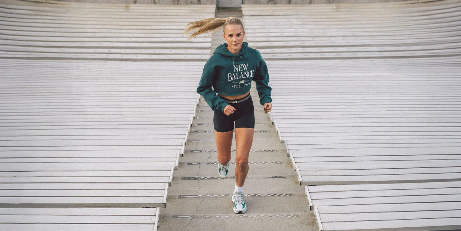 Parker Valby running up bleacher stairs  